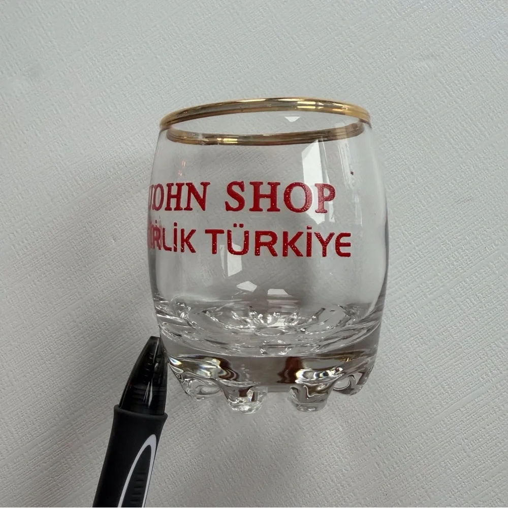 VTG I John Shop in‎ Incirlik, Türkiye shot glass in a gold rim & bold red text